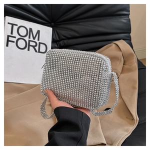 Close-up of a shimmering silver rhinestone square clutch with matching diamond chain