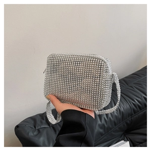 Macro shot of silver rhinestone square bag detailing with shimmering crystal shoulder strap