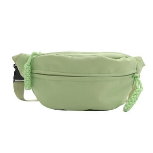 Minimalist mint green nylon belt bag with woven zipper pull and adjustable strap