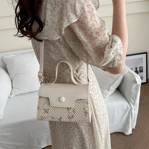 Borsa a mano da donna in ecopelle crema e paglia intrecciata con motivo floreale