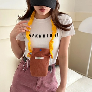 Brown corduroy crossbody phone bag with yellow ruffled strap and light blue drawstring