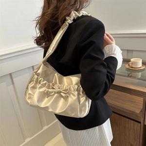 Elegant champagne satin shoulder bag with ruffle design and decorative bow for women