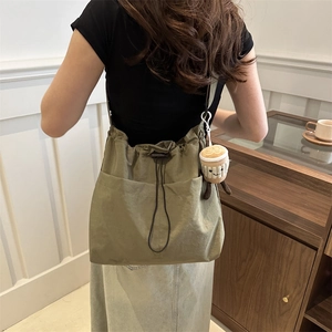 Grande borsa a tracolla verde oliva con coulisse e ciondolo a tazza di caffè in peluche