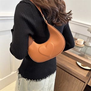 Brown faux leather crescent underarm bag with 3D heart embossing and wide strap