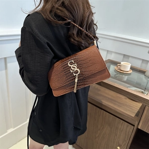 Brown crocodile-embossed underarm bag for women with gold SS logo and elegant tassel detail