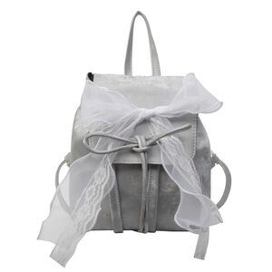 Silver grey velvet backpack with white lace bow detail for women in minimalist studio setting