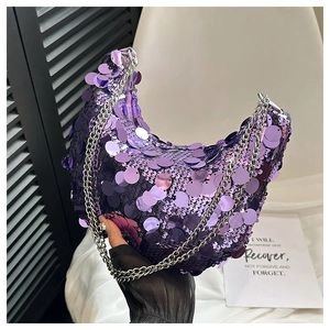 Detail of purple sequin crescent bag with silver chain strap held by model
