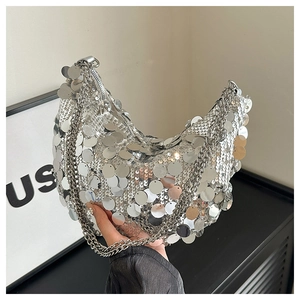 Close-up of silver hobo bag with large round sequins and metal chain strap details