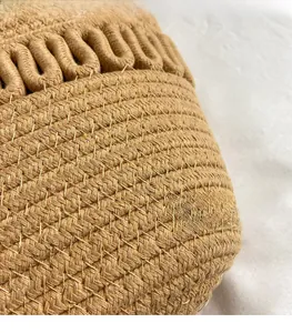 Macro shot of detailed caramel brown woven texture and handcrafted rope edge patterns