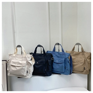Detail of four colorful canvas messenger bags showing multi-pocket design and crossbody straps
