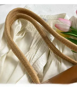 Macro shot of a sturdy brown rope strap on a French style straw woven shoulder bag
