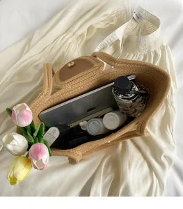 Interior detail of large woven straw tote showing ample space for iPad and essentials