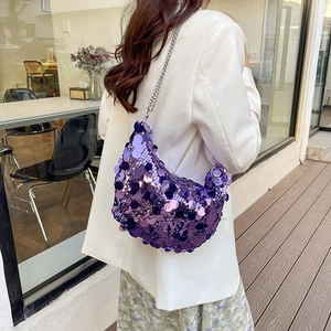 Purple sequin half-moon hobo bag with silver chain strap shown on a model