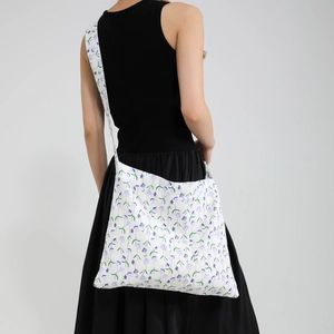 Fashionable floral tote bag for women featuring purple flower patterns and wide strap