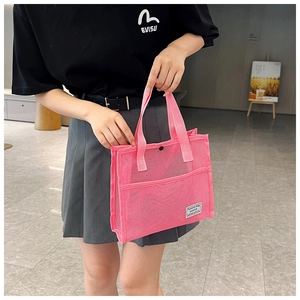 Modern pink mesh tote bag shown on a model, featuring a stylish portable handle design