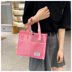 Detailed close-up of a pink mesh tote bag featuring a snap closure and fashion label