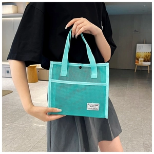 Detail of mint green mesh tote bag with reinforced handles and side pocket storage
