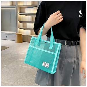 Detailed view of mint green mesh tote bag featuring breathable fabric and twin handles