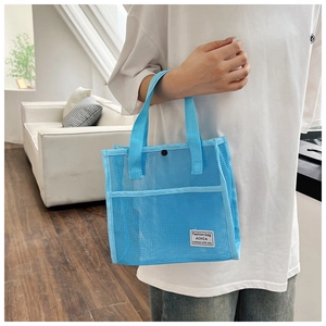 Detail view of the sky blue mesh tote bag showing breathable material and logo patch