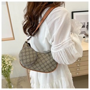 Vue détaillée du sac demi-lune avec motif vintage et petit porte-monnaie rond