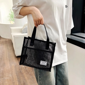 Large black mesh tote bag with durable handles for travel, beach, and swimming use