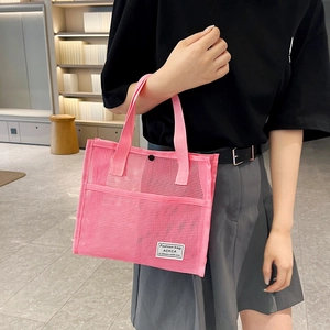 Pink mesh tote bag for travel and beach with durable handles and external pocket