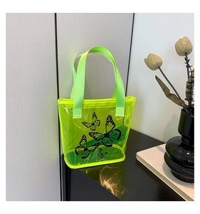 Detail view of the durable green nylon handles on the transparent butterfly tote bag