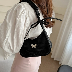 Fashionable black half-moon underarm bag with silver butterfly and ruffled strap for women