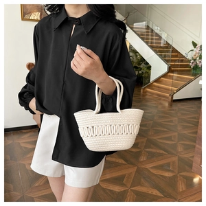 Détail de la texture crochetée blanche faite main et motifs tissés sur un sac seau d'été