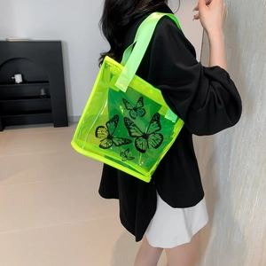 Neon green transparent PVC tote bag with butterfly print and matching shoulder straps