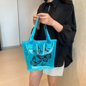 Blue transparent jelly tote bag with butterfly prints and sturdy fabric handles