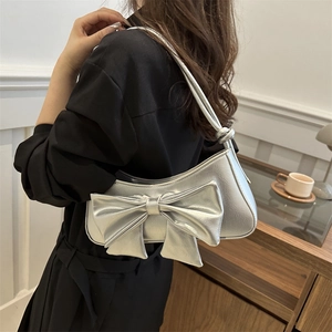 Chic metallic silver shoulder bag with large bow detail and textured finish for women