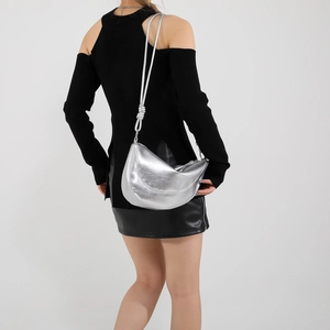 Metallic silver crescent saddle bag with pleated texture and adjustable strap