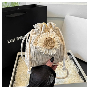 Detail of handmade cream crochet bucket bag featuring a large decorative sunflower