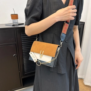 Three-color patchwork crossbody bag with gold lock and vintage pattern wide strap