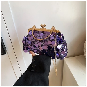 Detail of purple sequin evening bag with gold kiss-lock closure and metal chain strap