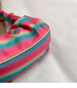 Detail showing gradient cloud bag with pleated texture and soft colorful finish