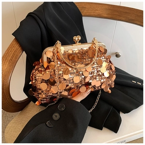 Close-up of luxury gold sequin evening bag with metal U-handle and vintage clasp