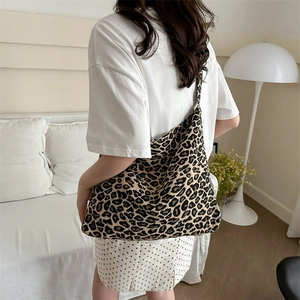 Chic leopard print canvas tote bag with large capacity in a cozy lifestyle setting