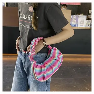 Close-up of pastel gradient pleated crescent bag with textured shoulder strap detail