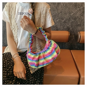Detailed close-up of rainbow gradient pleated cloud bag with ruffled handle design