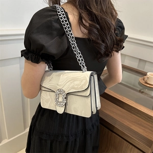 White marble pattern crossbody bag with rhinestone buckle and silver chain on model