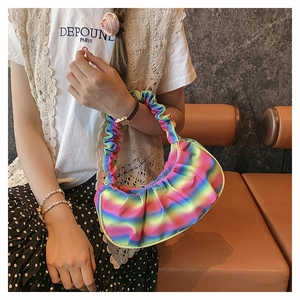 Detailed texture of rainbow gradient pleated cloud bag with vibrant crescent shape design