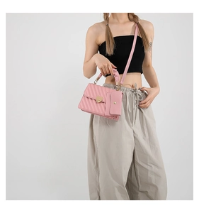 Close-up of pink quilted crossbody bag with heart magnetic buckle and mini coin pouch