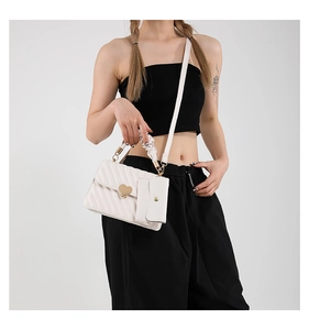 White textured shoulder bag with golden heart buckle and ruched cloud handle detail