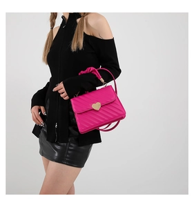 Detailed fuchsia quilted crossbody bag with golden heart-shaped metal lock and scrunchie handle