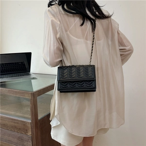 Chic black quilted chain crossbody bag with V-pattern texture and metal leather strap