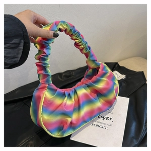 Close-up of rainbow gradient cloud bag featuring ruched handle and pleated nylon texture