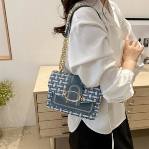 Fashionable blue tweed crossbody bag with gold chain strap and elegant oval metal buckle