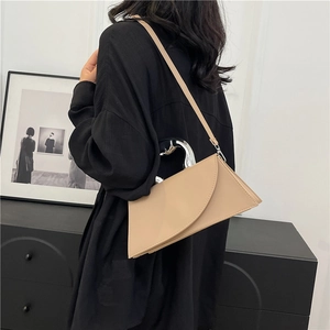 Chic beige geometric crossbody bag with a curved silver metal handle for a modern look